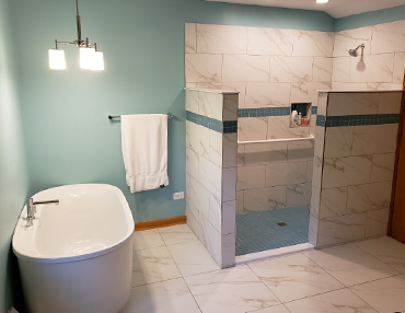 New Universal Design bathroom remodeling project with walk-in shower and freestanding tub. The flooring and walls are created with large format tile.